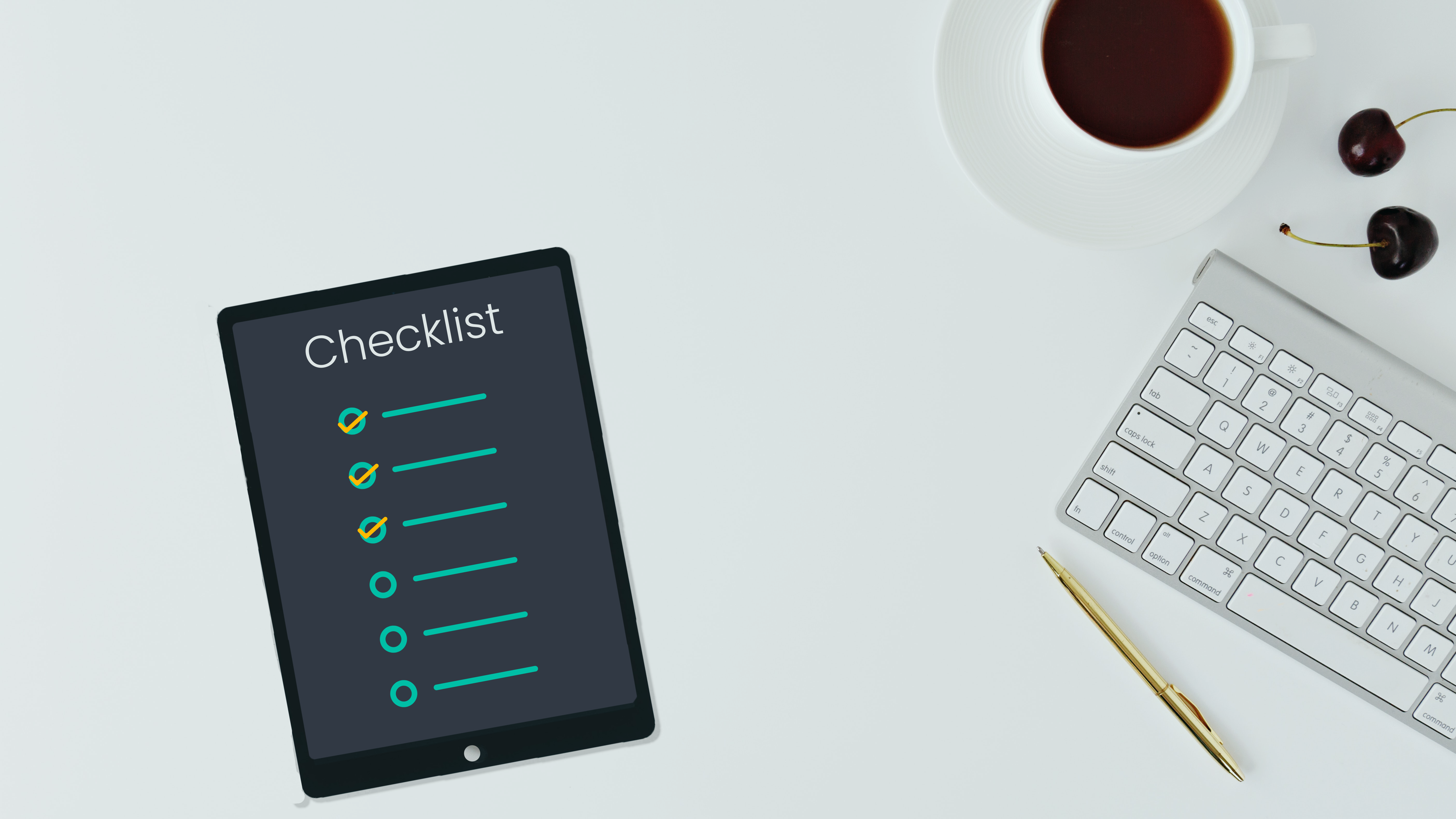 checklist on tab with keyboard and coffee